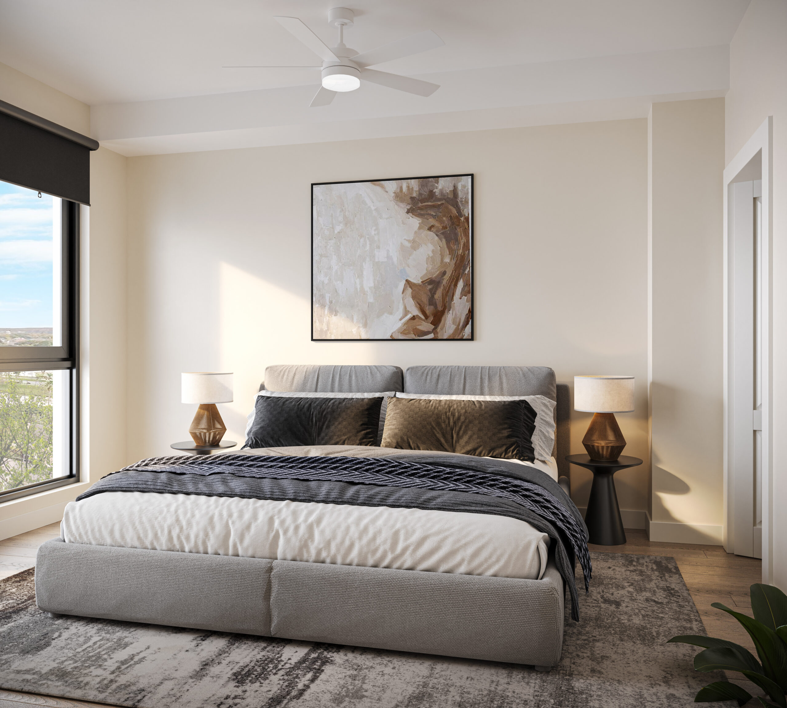 Modern bedroom with a gray bed, abstract wall art, two lamps on side tables, large window, and a neutral-colored rug.