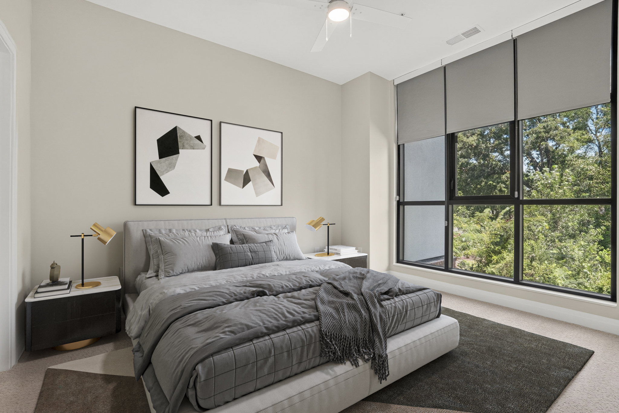 Modern bedroom with a large window, gray bedding, abstract wall art, and two bedside tables with lamps.